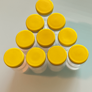 Yellow-capped vials arranged in a triangle
